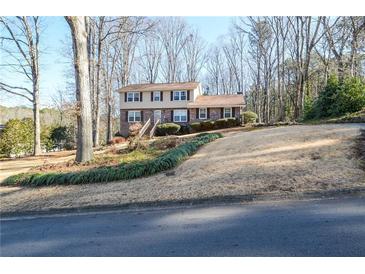 Charming two-story home with a brick facade, well-manicured lawn, and mature trees at 2265 Pine Point Dr, Lawrenceville, GA 30043