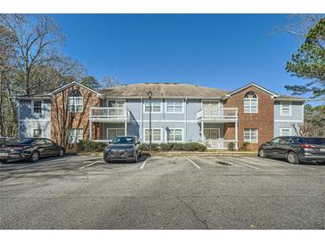 Inviting apartment building featuring brick accents and private balconies in a landscaped setting at 1342 Orchard Park Dr, Stone Mountain, GA 30083