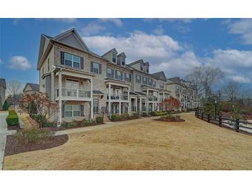 Charming townhomes with brick facade, white trim, and small private balconies create an inviting curb appeal at 2203 Fullers Aly, Kennesaw, GA 30144