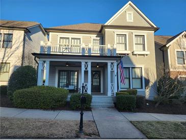 Charming two-story home with a welcoming front porch and manicured landscaping at 3831 Portland Trail Dr, Suwanee, GA 30024