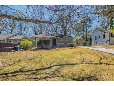 Charming single-story home with a well-maintained lawn and inviting front porch at 2103 Mcafee Rd, Decatur, GA 30032