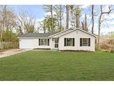 Charming single-story home with a well-maintained lawn and a one car garage at 3753 Adamsville Sw Dr, Atlanta, GA 30331