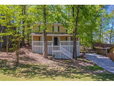 Charming two-story home featuring a welcoming front porch and landscaped front yard at 3500 Quinn Ridge Dr, Snellville, GA 30039