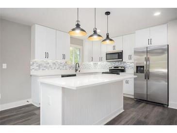 Modern kitchen features white cabinets, stainless steel appliances, and quartz countertops at 1381 Flat Rock Rd, Stockbridge, GA 30281
