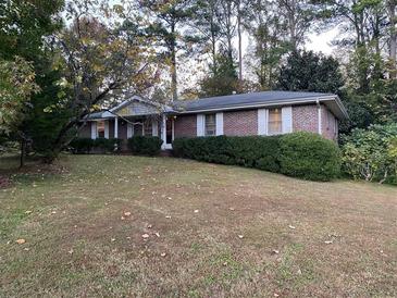 Charming single-story brick home featuring a well-manicured front yard at 866 Casco Nw Dr, Lilburn, GA 30047