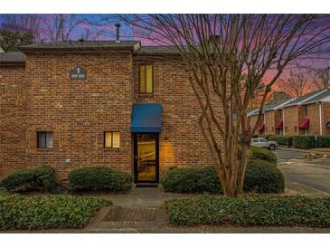 Brick building exterior with a blue awning and walkway at 2251 Pernoshal Ct, Atlanta, GA 30338