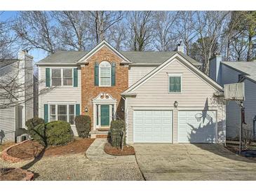 Charming two-story home with a two-car garage and mature landscaping at 10965 Glenbarr Dr, Johns Creek, GA 30097