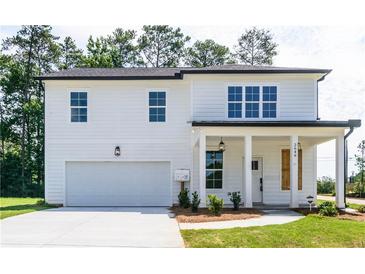 Charming two-story home features white siding, a covered porch, and a two-car garage at 2475 Adair Ridge Ct, Decatur, GA 30034