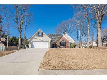 Charming single-Gathering home featuring a manicured front lawn and a two-car garage at 557 Bradford Park, Loganville, GA 30052