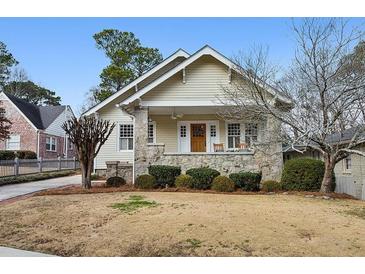 Charming bungalow with stone accents, covered porch, and manicured front lawn at 2120 Mckinley Nw Rd, Atlanta, GA 30318