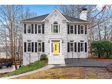 Charming two-story brick home with black shutters and a welcoming yellow front door at 3524 Pine Grove Drive, Douglasville, GA 30135