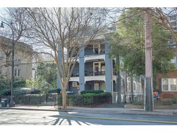 Charming three-story building with iron balconies and wrought iron fence adding to its appeal at 259 14Th Ne St # 104, Atlanta, GA 30309