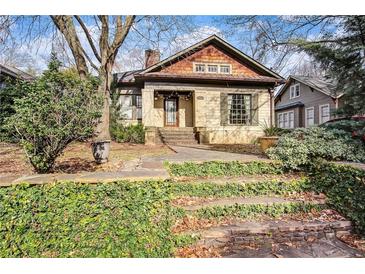 Charming brick home with cedar shake accents, beautiful stone steps and inviting curb appeal at 946 Highland Ne Vw, Atlanta, GA 30306