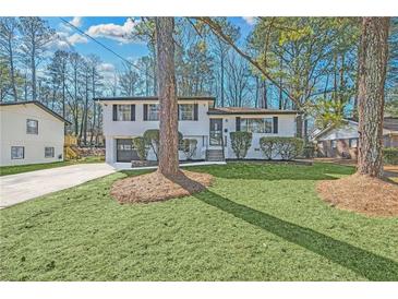 Charming, updated two-story home with a well-manicured lawn and inviting curb appeal at 6670 Hidden Brook Trl, Atlanta, GA 30349