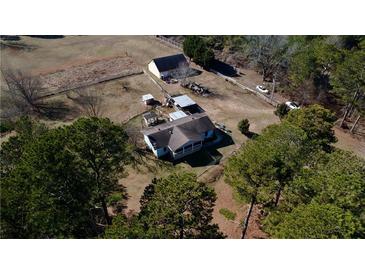 Expansive property featuring a charming home, barn, fenced yard, and ample space at 5570 Bold Springs Rd, Dacula, GA 30019