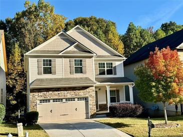 Charming two-story home with stone accents and a well-manicured lawn at 91 Reynoldston Ct, Suwanee, GA 30024