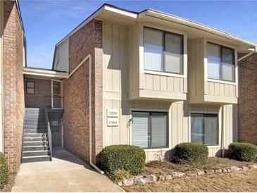 Inviting exterior of a two-story townhome with brick accents and well-maintained landscaping at 2064 Powers Ferry Se Trce, Marietta, GA 30067