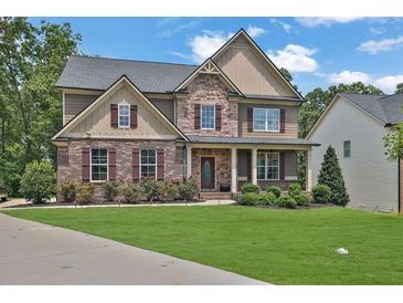 Charming two-story home with a combination brick and stone facade and well-manicured lawn at 48 Scenic Ovlk, Acworth, GA 30101