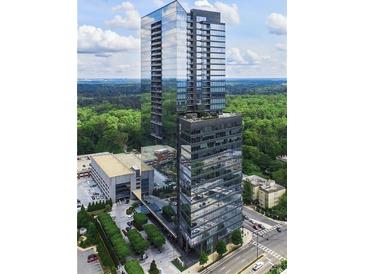 Modern high-rise condo with a beautiful glass exterior and green surroundings at 3630 Peachtree Ne Rd # 3401, Atlanta, GA 30326
