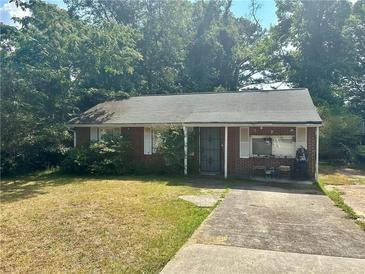 Cozy brick home features a classic design and a traditional front yard at 5278 Madison St, Forest Park, GA 30297
