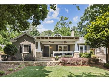 Charming one-story home with a covered front porch, manicured lawn, and lush landscaping at 167 Freyer Ne Dr, Marietta, GA 30060