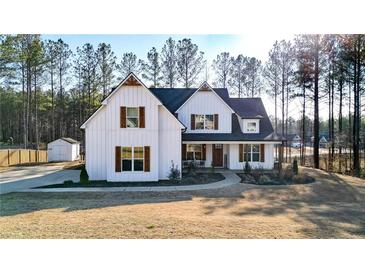 Beautiful two-story home with a covered front porch, wood accents, and a well-maintained lawn at 71 Presley Farm Ln, Rockmart, GA 30153