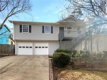 Charming two-story home with a two-car garage and an inviting front entrance with stairs at 3764 Cherokee Overlook Dr, Canton, GA 30115