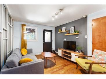 Cozy living room with a gray sofa, modern light fixture and flatscreen TV at 562 Formwalt Sw St # 5, Atlanta, GA 30312