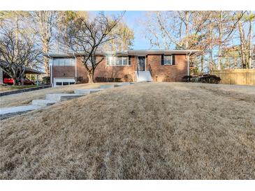 Charming single-story brick home featuring a well-manicured lawn and inviting front entrance at 1722 Detroit Nw Ave, Atlanta, GA 30314