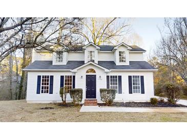 Charming two-story home featuring a well-maintained yard and classic architectural details at 1198 Oak Knoll Ct, Lithonia, GA 30058
