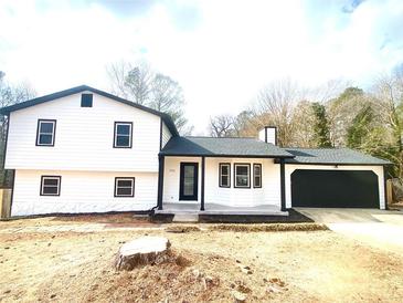 Newly renovated two-story home with black trim and an attached garage at 506 Sheppard Rd, Stone Mountain, GA 30083