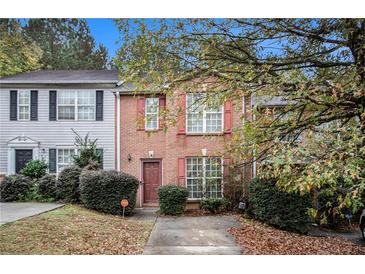 Charming brick townhome with red shutters and manicured landscaping at 338 Saratoga Pl, Riverdale, GA 30296