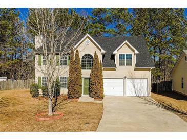 Charming two-story home with a well-maintained lawn, a two-car garage, and mature trees at 2695 Virginia Cv, South Fulton, GA 30296