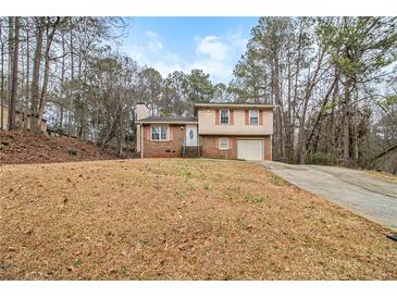 Charming two-story brick home with a well-maintained front yard and a classic suburban appeal at 620 Bell Se Rd, Conyers, GA 30094