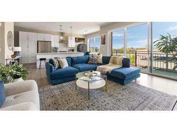 Bright living room featuring a large sectional sofa, rug, and a view from sliding glass doors at 22 Airline Ne St # 403, Atlanta, GA 30312
