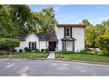 Charming two-story home with a landscaped yard, white brick, black shutters and a manicured lawn at 2861 Dorby Close Ne, Brookhaven, GA 30319