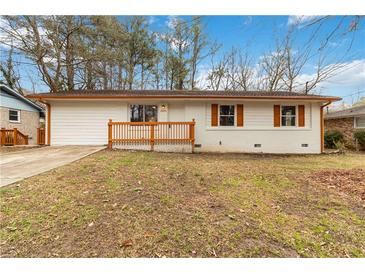 Charming single-story home with white brick, brown accents, and a cozy front porch at 2825 Middleburg Dr, Atlanta, GA 30349