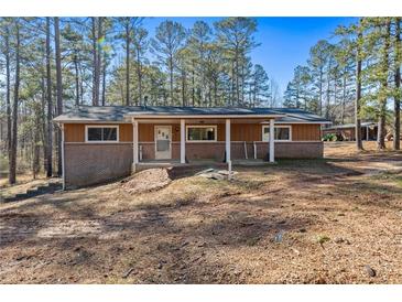 Charming single-story home featuring a covered front porch and partially brick exterior at 202 Neely Rd, Fayetteville, GA 30214