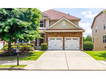 Charming two-story home with a well-manicured front yard and a two-car garage at 3455 Dalwood Dr, Suwanee, GA 30024