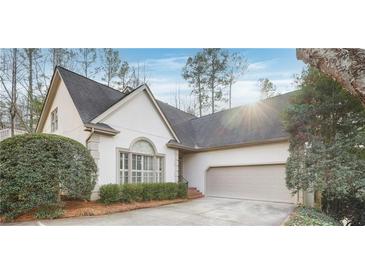 Charming home featuring manicured landscaping and a two-car garage at 3923 Ashford Ne Trl, Brookhaven, GA 30319