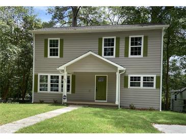 Charming two-story home with green shutters, a front porch, and a well-maintained lawn at 577 Center Hill Nw Ave, Atlanta, GA 30318