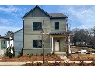 Charming two-story home featuring a covered front porch and neutral siding at 3326 Springhaven Ave, Hapeville, GA 30354