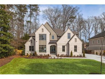 Beautiful new construction home with a lush front lawn and sophisticated architectural details at 2657 Ashford Ne Rd, Brookhaven, GA 30319