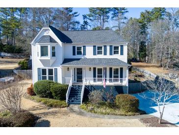 Charming two-story home with landscaped yard, classic shutters, and inviting front porch with black stairs at 2167 Tully Wren Ne, Marietta, GA 30066