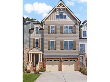 Charming three-story townhome with a brick foundation and a two-car garage at 300 Trecastle Ln # 26, Canton, GA 30114