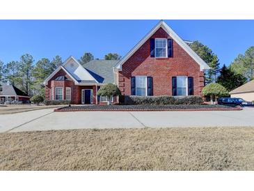 Charming brick home with a well-manicured lawn and mature trees in a desirable neighborhood at 337 Inverness Ave, Mcdonough, GA 30253