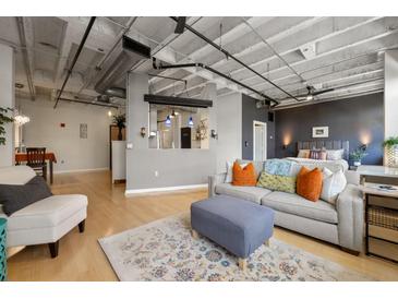 Spacious living room features an open layout with modern furniture and a view to the bedroom at 878 Peachtree Ne St # 431, Atlanta, GA 30309