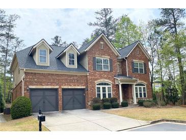 Lovely two story brick home with dormer windows and attached two car garage at 3553 Old Maple Dr, Johns Creek, GA 30022