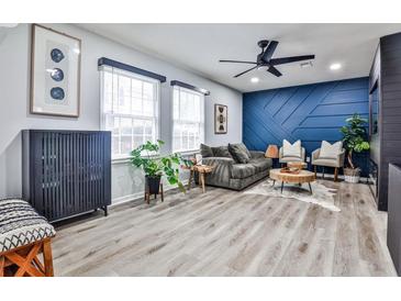 Bright living room featuring hardwood floors, modern decor, and a cozy seating arrangement at 15 Pine Canyon Sw Dr, Atlanta, GA 30331