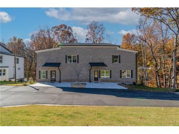 New construction gray brick duplex with black shutters and ample parking at 2381 Highpoint Rd, Snellville, GA 30078